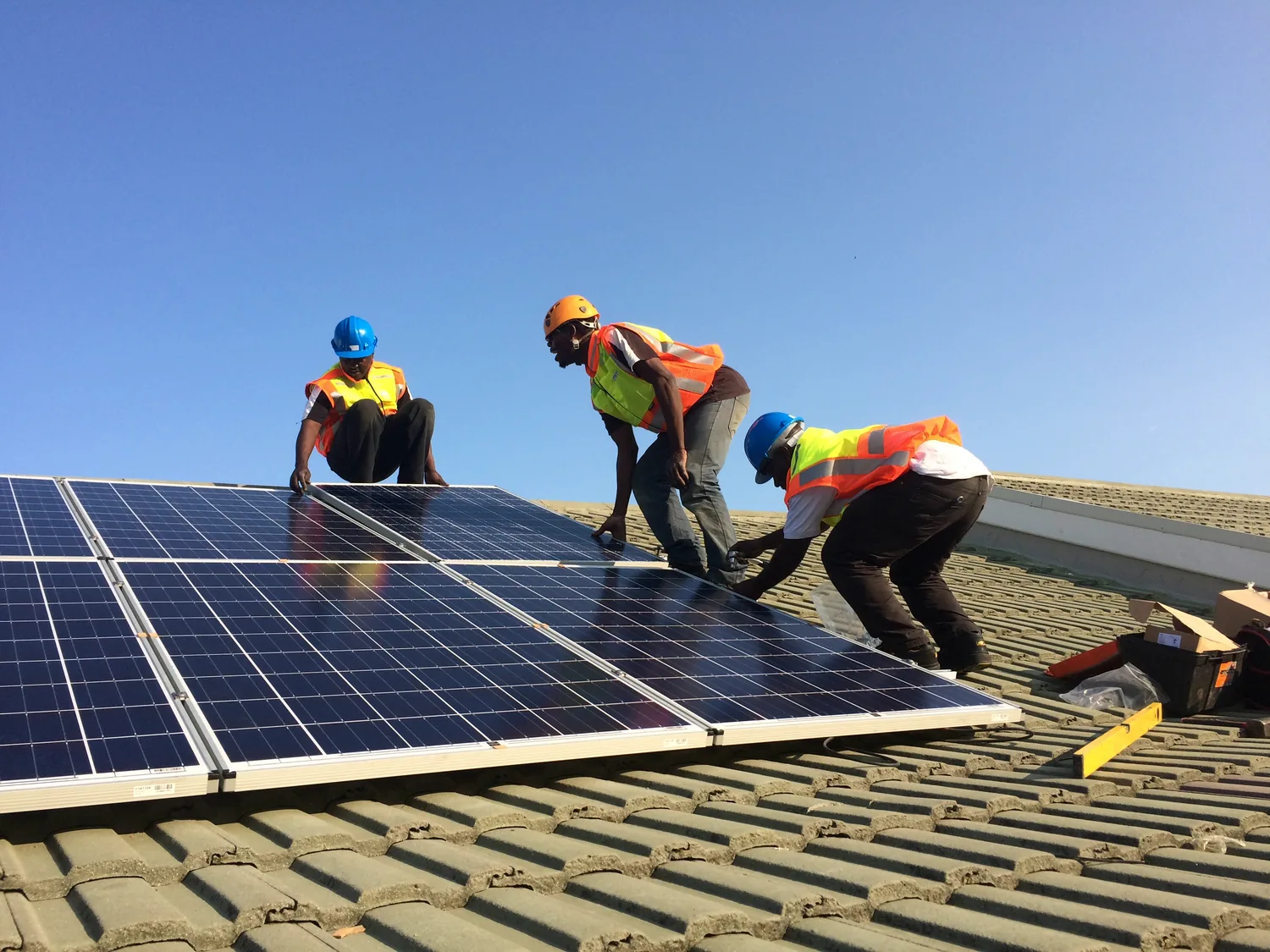 MSNT team mounting solar panels on a pitched roof