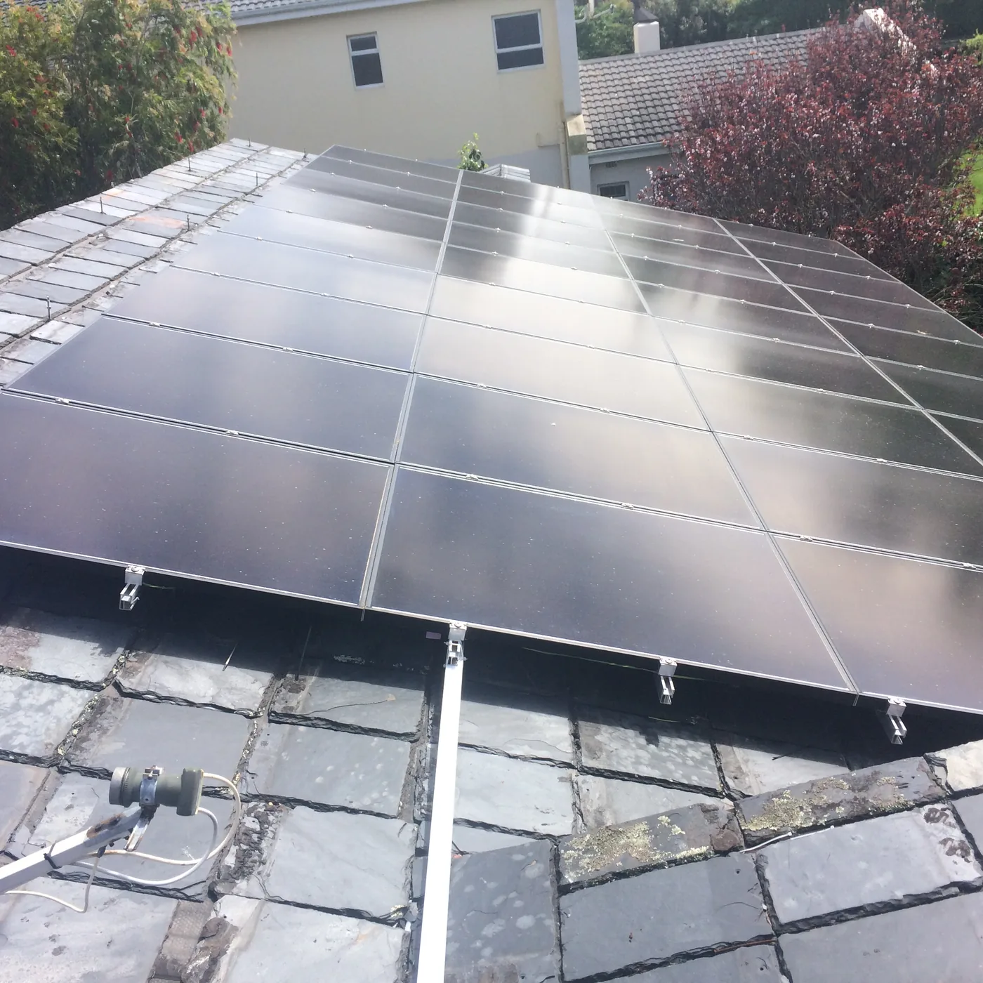 Solar panels on a flat roof, paired with wind generation